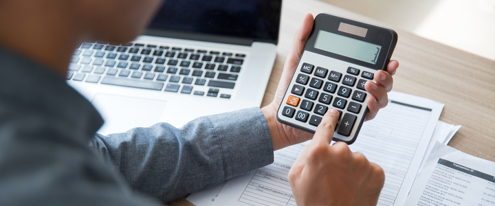 A man using a calculator