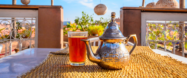 A teapot on a table on a balcony overlooking Marrakech