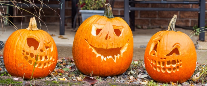 Carved pumpkins outside a house