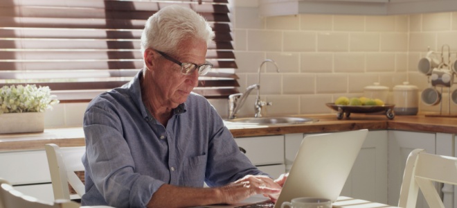 Older man working at a laptop