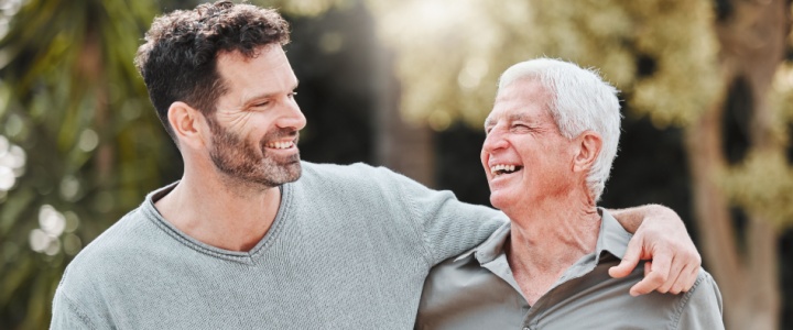 Elderly father and son laughing together
