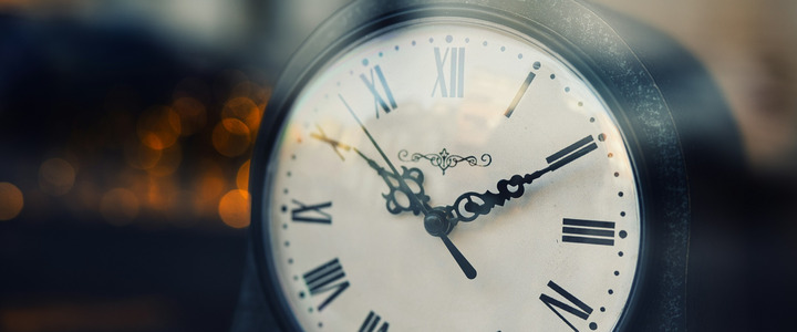 An antique clock in a window